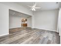 Open-concept living room with hardwood floors flowing into adjacent kitchen area at 6816 Park Square Dr # C, Avon, IN 46123