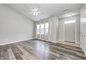 Bright living room featuring hardwood floors, large windows, and modern ceiling fan at 6816 Park Square Dr # C, Avon, IN 46123