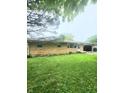 Well-maintained brick ranch home with a lush green lawn at 7109 Chandler Dr, Indianapolis, IN 46217