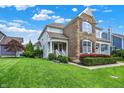 Landscaped lawn and plantings compliment the exterior of this two-story home with a stone facade and inviting front porch at 7614 Bishops, Zionsville, IN 46077