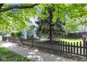 Lovely home exterior with a lush green lawn, fence, and mature shade tree at 767 Fletcher Ave, Indianapolis, IN 46203
