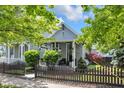Charming home with manicured landscaping, picket fence, and covered front porch at 767 Fletcher Ave, Indianapolis, IN 46203