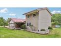 Two-story home with vinyl siding, red roof, covered porch and well-maintained landscaping at 775 Baker Rd, Martinsville, IN 46151