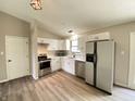 Bright kitchen featuring stainless steel appliances, modern white cabinets and a window above the sink at 817 Delray Dr, Indianapolis, IN 46241