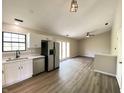 Open-concept kitchen with stainless steel appliances and white cabinets seamlessly connects to the living area at 817 Delray Dr, Indianapolis, IN 46241