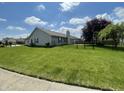The house has a well-maintained yard and a covered patio perfect for backyard entertaining at 8234 Crosser Dr, Indianapolis, IN 46237
