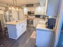 Bright kitchen featuring stainless steel appliances, white cabinets, a center island, and modern pendant lighting at 8798 Surrey Dr, Pendleton, IN 46064