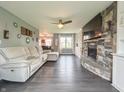 Comfortable living room with a stone fireplace, large TV, and a cozy sectional sofa at 8798 Surrey Dr, Pendleton, IN 46064