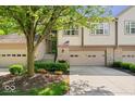 Charming townhome showcasing a well-maintained front yard and inviting entrance with a garage at 9317 Muir Ln, Fishers, IN 46037