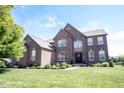 Beautiful two-story brick home featuring manicured lawn and landscaping at 10267 Ranford Blvd, Fishers, IN 46040