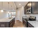 Gourmet kitchen with a center island, granite countertops, stainless steel appliances, and open layout at 10307 Gateway Dr, Brownsburg, IN 46234