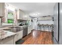 Bright kitchen with stainless steel appliances, granite countertops, and hardwood floors at 1107 N Hartman Dr, Indianapolis, IN 46219