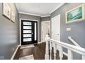 Inviting foyer showcasing dark hardwood floors, neutral walls, and elegant white trim at 11319 Shoreview Ln, Indianapolis, IN 46236