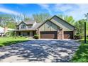 This stunning home boasts an attached three car garage and a large driveway at 11471 Clarkston Rd, Zionsville, IN 46077