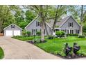 Well-maintained gray house with an attached garage, mature landscaping, and inviting curb appeal at 11550 Clarkston Rd, Zionsville, IN 46077
