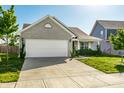 Well-maintained single-Gathering home with a two-car garage, concrete driveway, and neat landscaping on a sunny day at 1221 Danielle Rd, Lebanon, IN 46052