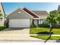 Lovely house features a two-car garage, brick and siding exterior, and a well-kept lawn at 1221 Danielle Rd, Lebanon, IN 46052