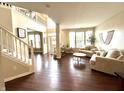 Bright, spacious living room with high ceilings, hardwood floors, and large windows offering plenty of natural light at 1454 Woodfield Dr, Greenwood, IN 46143
