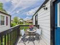 Cozy outdoor patio space with seating for two, perfect for relaxing and enjoying the neighborhood view at 1505 E 30Th St, Anderson, IN 46016