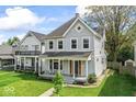 Beautiful two-story home with a quaint covered porch and lush green lawn at 1505 Spann Ave, Indianapolis, IN 46203
