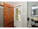 Welcoming entryway featuring a modern front door and stylish decor elements and wood floors at 1701 Lincoln Rd, Speedway, IN 46224
