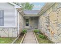 Charming front entryway featuring stone accents, a cozy covered porch, and a well-maintained walkway at 2444 S Brandywine Ct, Greenfield, IN 46140