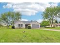 Charming ranch-style home with an attached two-car garage and a beautifully maintained lawn and landscaping at 2444 S Brandywine Ct, Greenfield, IN 46140