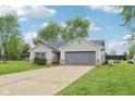 Charming ranch-style home with an attached two-car garage and driveway, as well as a well-manicured lawn at 2444 S Brandywine Ct, Greenfield, IN 46140