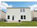 Rear view of a house with a patio, well-kept lawn, and a door for easy outdoor access at 2545 Harvest Moon Dr, Greenwood, IN 46143