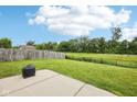 Expansive backyard featuring lush grass, a concrete patio, and a fire pit for outdoor enjoyment at 2545 Harvest Moon Dr, Greenwood, IN 46143