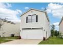 Side view showing a home's white siding, garage, and well-maintained lawn at 2545 Harvest Moon Dr, Greenwood, IN 46143