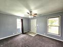 Neutral living room with carpet, fan, and natural light from two windows at 2737 S Roena St, Indianapolis, IN 46241