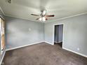 Cozy living room featuring neutral carpet, fan, and access to other rooms at 2737 S Roena St, Indianapolis, IN 46241