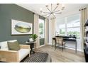 Stylish home office with a black desk, comfortable chair, modern lighting, and calming green accent wall at 3873 Goodwin Dr, Zionsville, IN 46077
