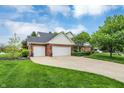 Spacious home boasting an attached three-car garage and a wide driveway, perfect for Gathering living at 3996 Brockton Manor N Dr, Greenwood, IN 46143