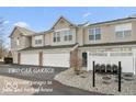 Townhouse exterior featuring two-car garage and private entrance with a shared mailbox system at 4104 Bullfinch Way, Westfield, IN 46062