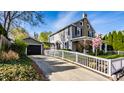 Charming two-story home with driveway leading to garage and covered patio at 413 E 40Th St, Indianapolis, IN 46205