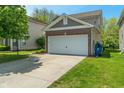 Picture of home with attached two-car garage, brick facade, and green lawn on a sunny day at 4136 Orchard Valley Ln, Indianapolis, IN 46235