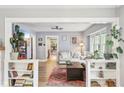 Bright living room with hardwood floors, cozy seating, and built-in bookshelves at 4245 Guilford Ave, Indianapolis, IN 46205