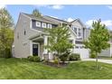 Beautiful two-story home featuring gray siding, a well-maintained lawn, and a two-car garage at 4629 Rainwater Ln, Whitestown, IN 46075