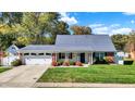 Attractive single-story home showcasing a manicured lawn, brick accents, and an attached two-car garage at 51 Wilson Dr, Carmel, IN 46032