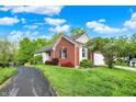 Attractive brick home with lush landscaping, a driveway, and a two-car garage at 5348 Pelham Way, Indianapolis, IN 46216