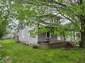 Home exterior with fresh gray paint, a small front porch, and mature trees at 550 W King St, Franklin, IN 46131