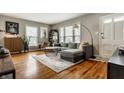 Inviting living room with hardwood floors, plush seating, and plenty of natural light at 5643 Rosslyn Ave, Indianapolis, IN 46220