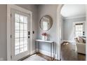 A welcoming entryway with a modern table, round mirror, and an arched doorway at 5829 Broadway St, Indianapolis, IN 46220