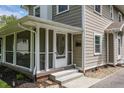 Close up of front porch entrance with tiled steps and a white framed screen door at 5829 Broadway St, Indianapolis, IN 46220