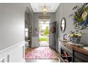 Welcoming foyer featuring a decorative rug, console table, and view of the front door at 6150 Rolling Rock Ln, Noblesville, IN 46062