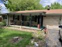 Inviting covered front porch with decorative iron supports and porch swing perfect for relaxing outdoors at 6430 E Stop 11 Rd, Indianapolis, IN 46237