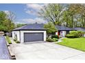 White brick home with attached garage, manicured lawn and garden at 7245 Highburry Dr, Indianapolis, IN 46256