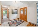 Inviting entryway features tile flooring, a stylish front door, and fresh paint, creating a warm welcome at 7420 Denton Cir, Indianapolis, IN 46256